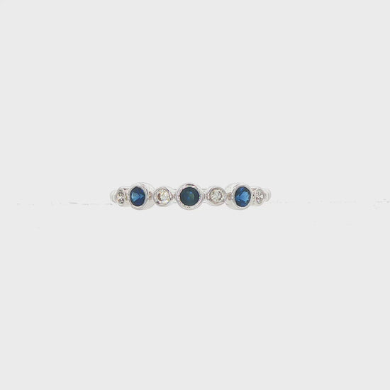 18K White gold band bezel set with blue sapphires and round brilliant diamonds. Item J36395 - ABC Jewelry Co. 