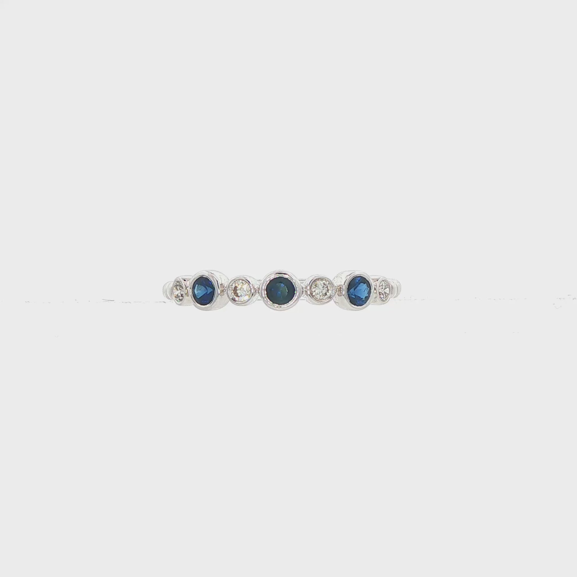 18K White gold band bezel set with blue sapphires and round brilliant diamonds. Item J36395 - ABC Jewelry Co. 