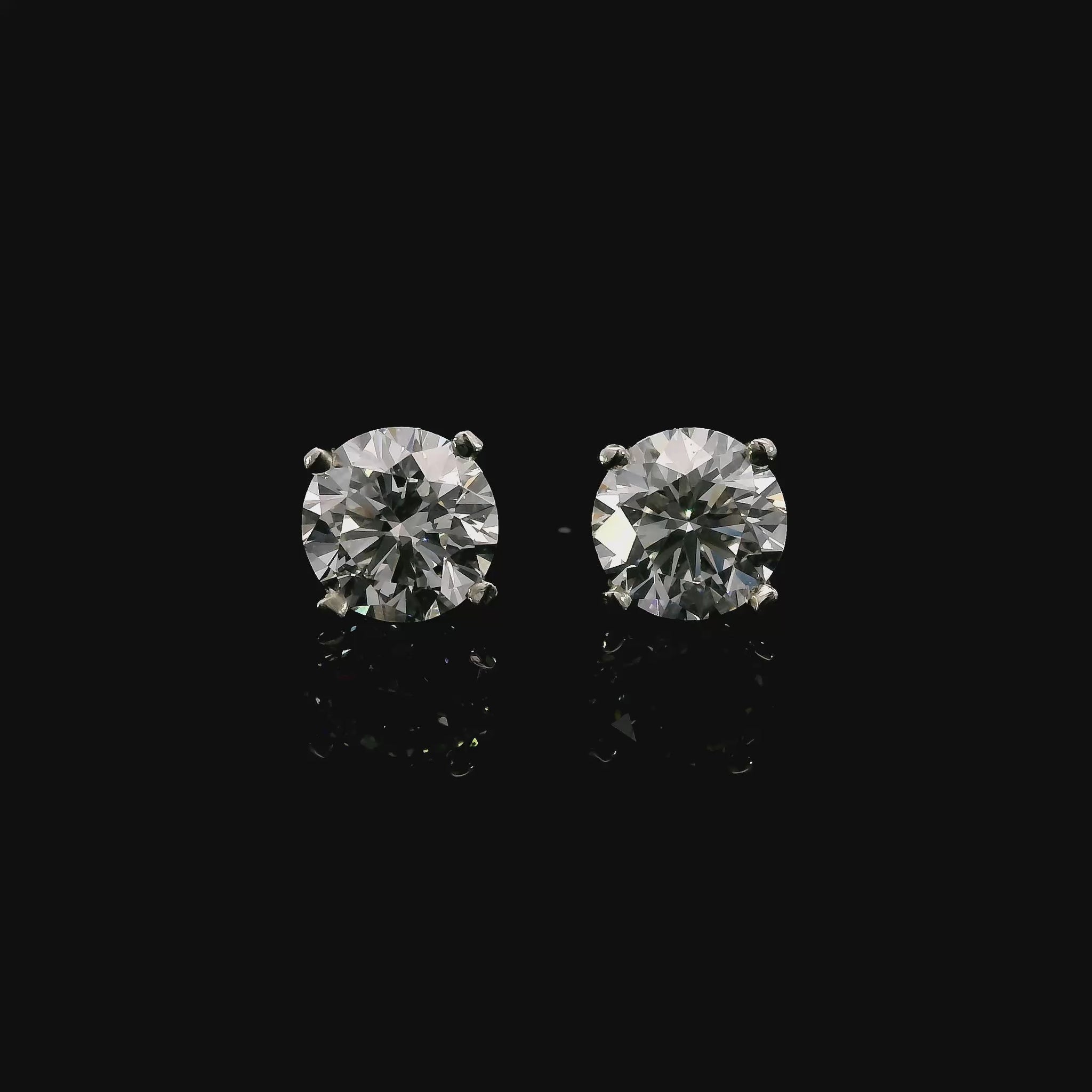 14K White gold stud earrings set with round brilliant diamonds. Item J37810 - ABC Jewelry Co.