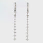 18K White gold dangle earrings with a vertical cascade of round brilliant diamonds. Item J36006 - ABC Jewelry Co