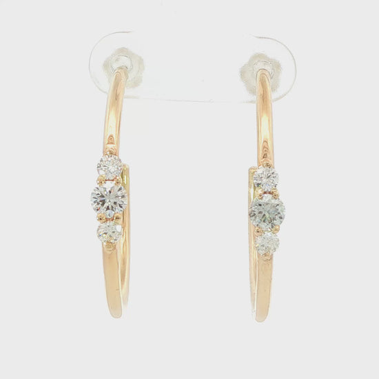 14K Yellow gold hoop earrings each set with a row of three round brilliant diamonds. Item J39217 - ABC Jewelry Co. 