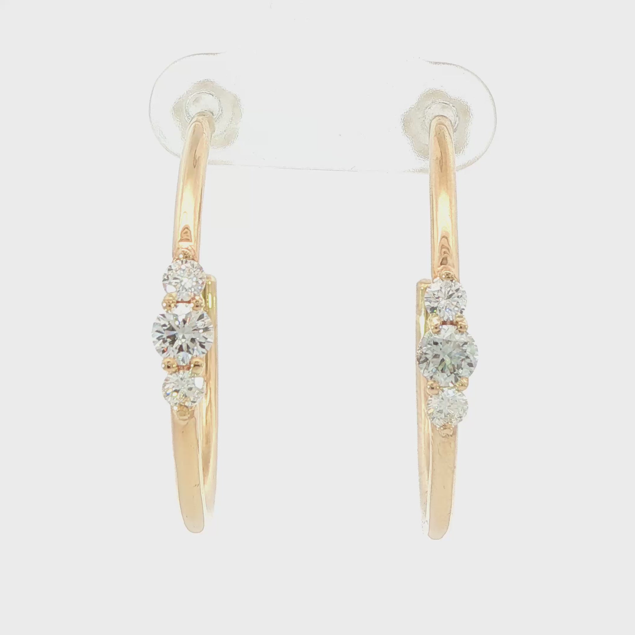 14K Yellow gold hoop earrings each set with a row of three round brilliant diamonds. Item J39217 - ABC Jewelry Co. 