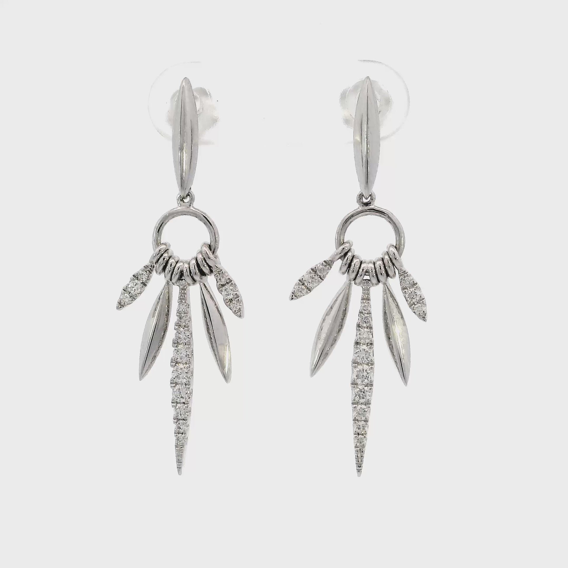 18K White gold earrings with marquise inspired drops set with round brilliant diamonds. Item J36882 - ABC Jewelry Co