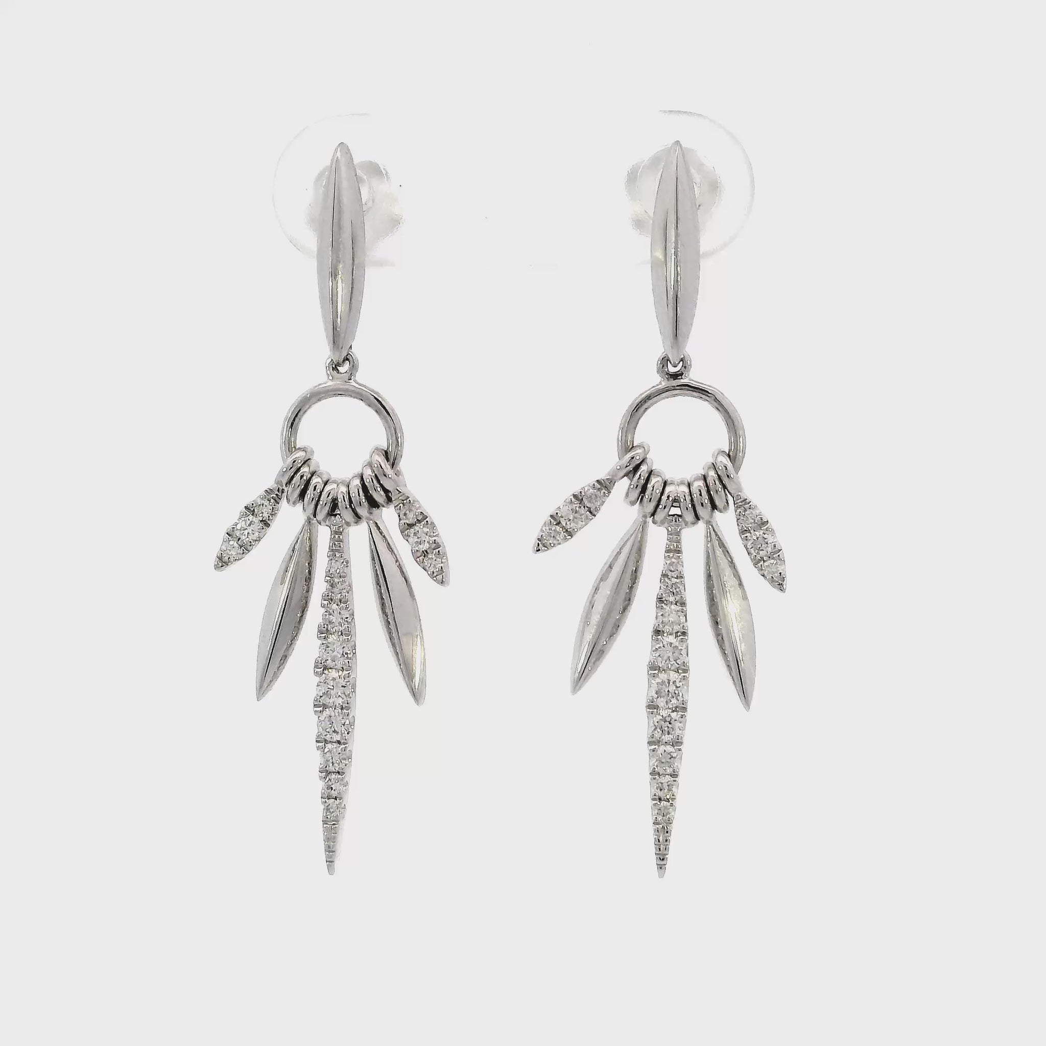 18K White gold earrings with marquise inspired drops set with round brilliant diamonds. Item J36882 - ABC Jewelry Co