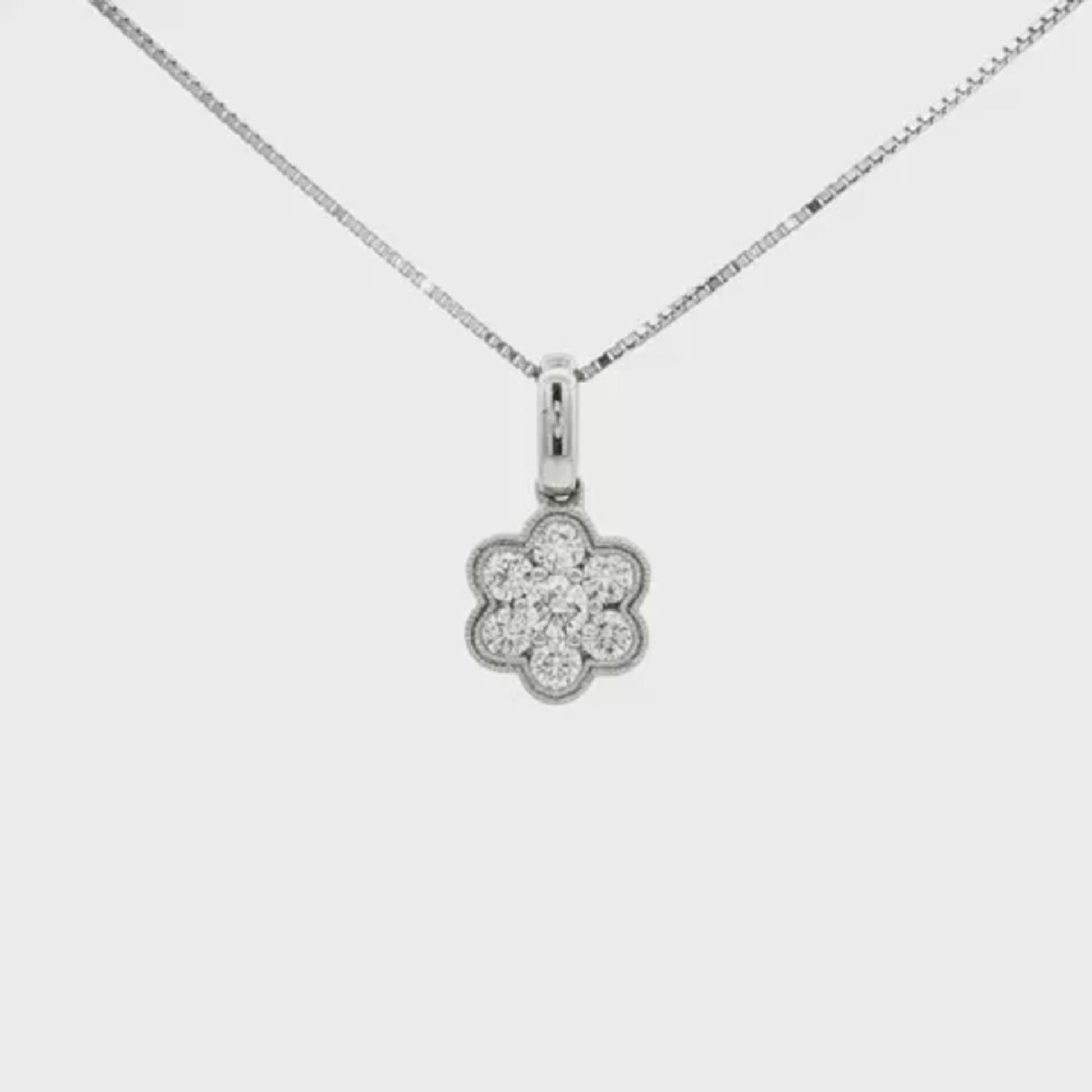 Diamond cluster pendant in floral design, set with round brilliant diamonds. Item J30348 - ABC Jewelry Co.