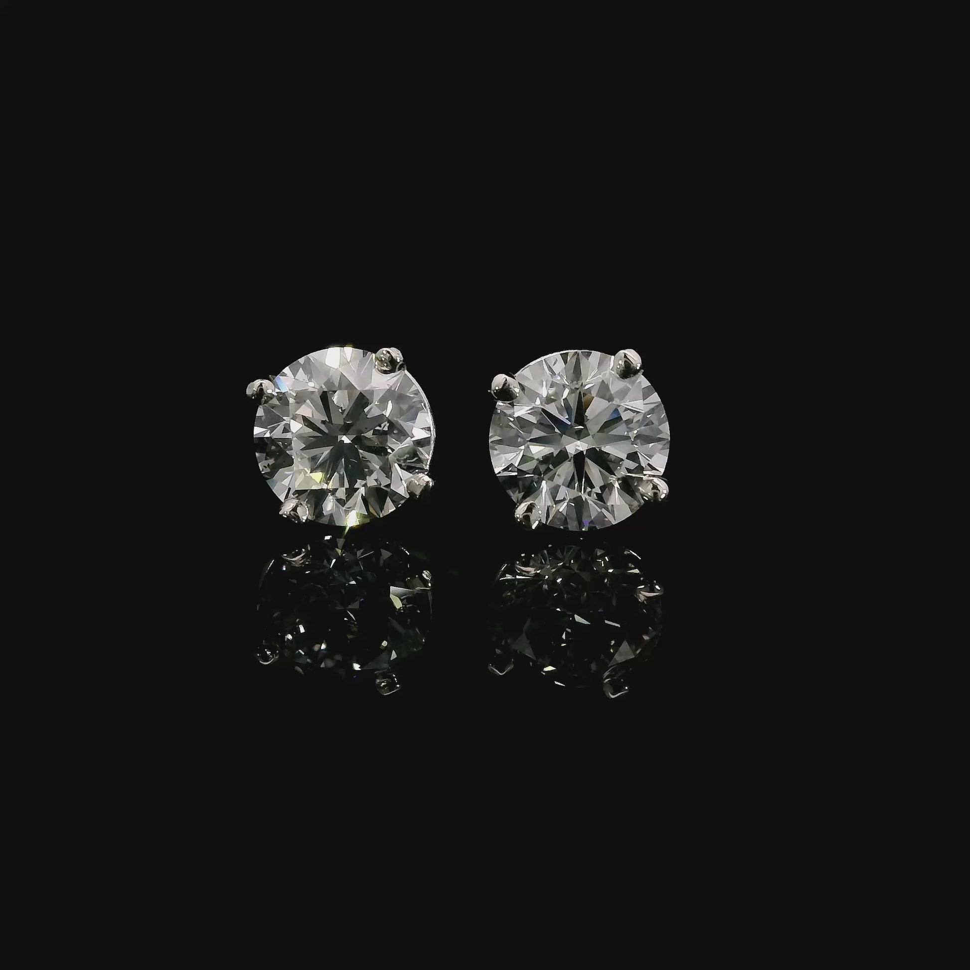 14K White gold studs set with round brilliant diamonds. Item J38705 - ABC Jewelry Co. 