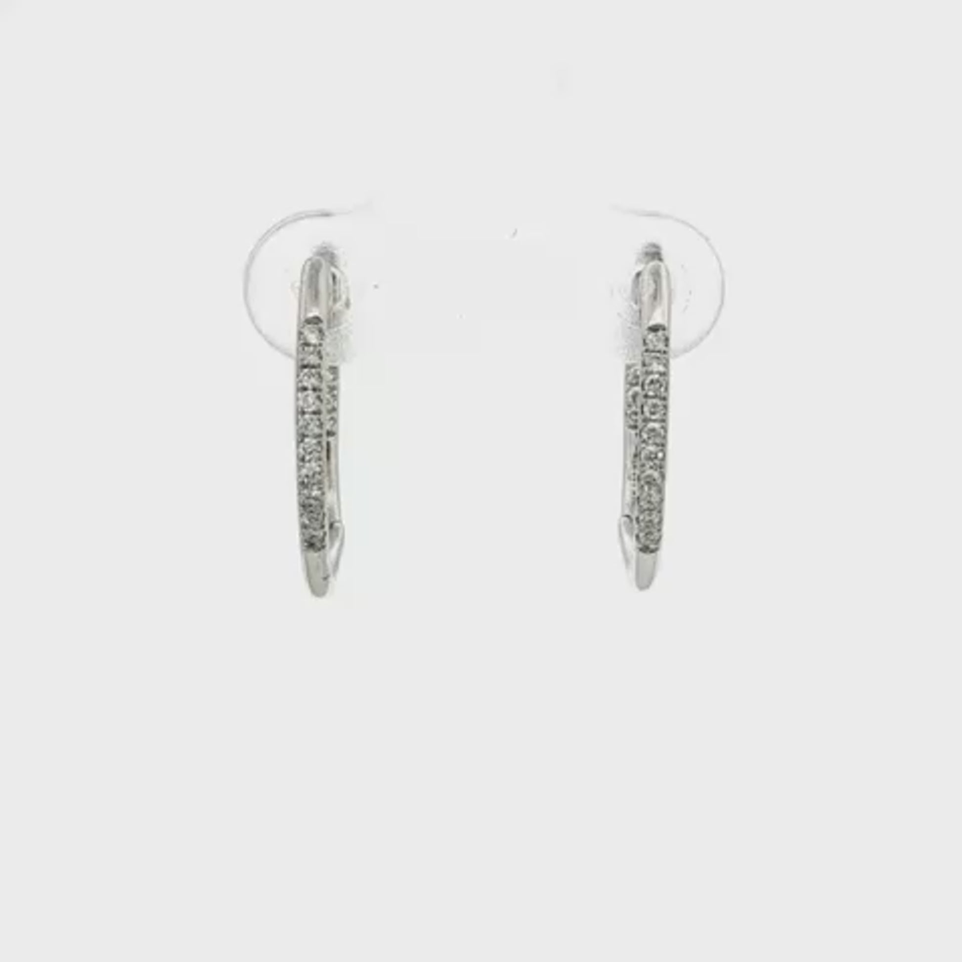 14K White gold hoop earrings accented with a row of round brilliant diamonds. Item J35835 - ABC Jewelry Co. 