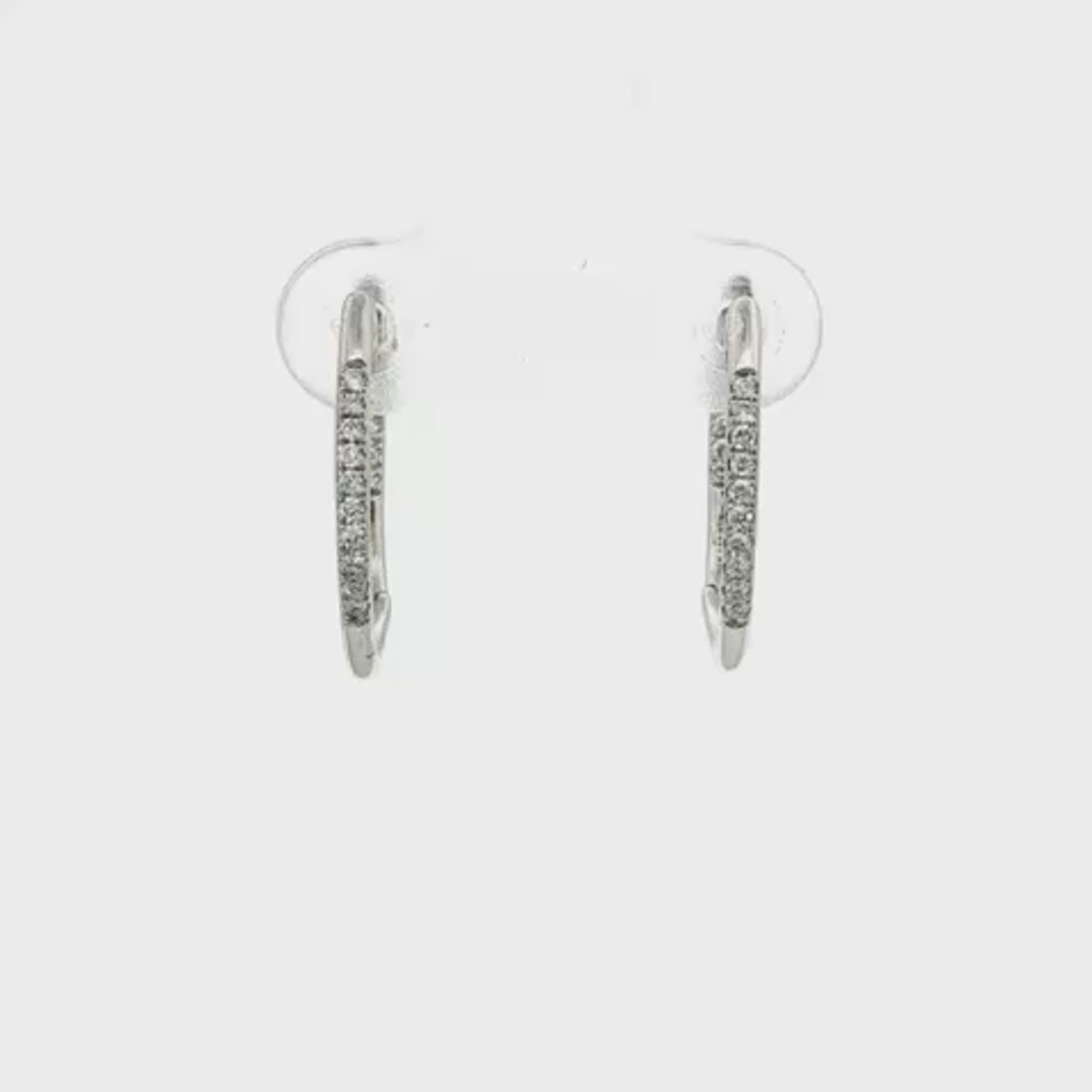 14K White gold hoop earrings accented with a row of round brilliant diamonds. Item J35835 - ABC Jewelry Co. 