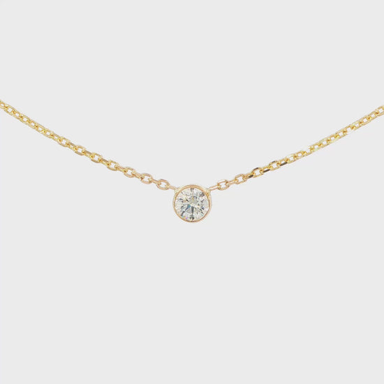 14K Yellow gold necklace with one bezel set round brilliant diamond. Item J38629 - ABC Jewelry Co. 