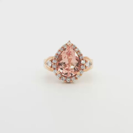 14K Rose gold ring set with a pear shape morganite surrounded with a diamond halo. Item J33283 - ABC Jewelry Co. 