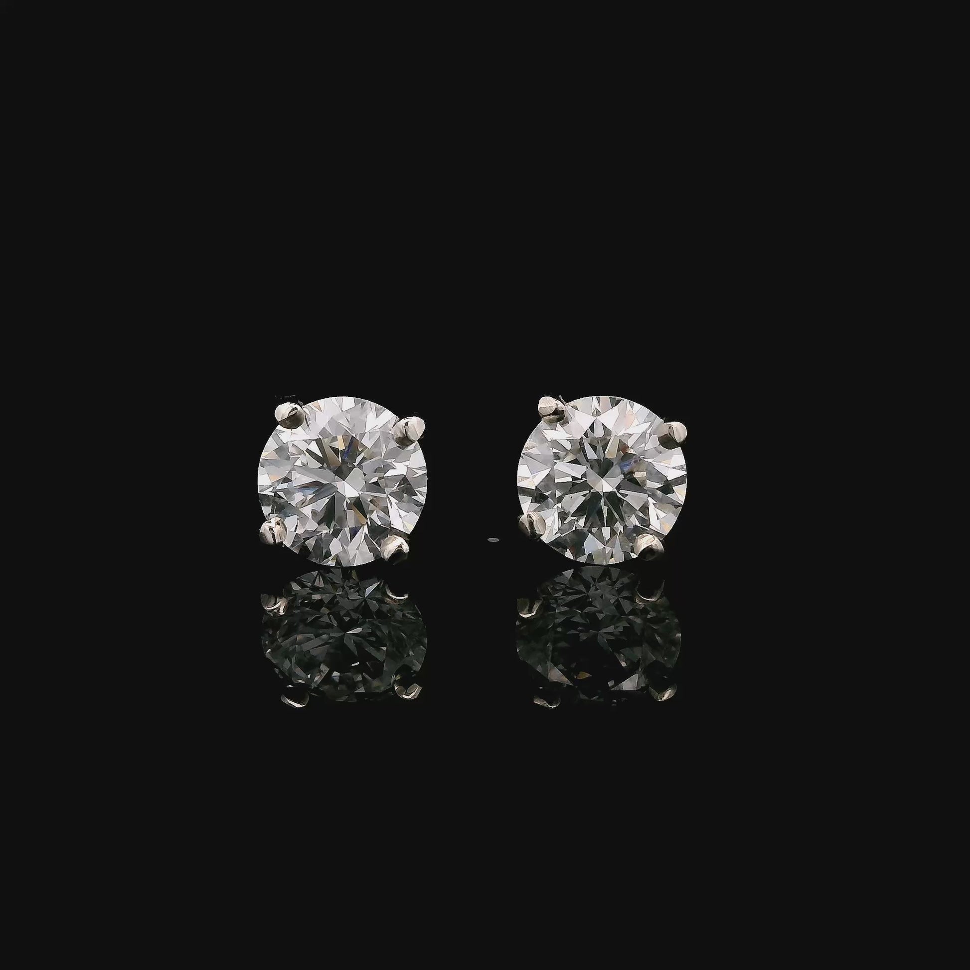 14K White gold stud earrings set with round brilliant diamonds. Item J37987 - ABC Jewelry Co. 