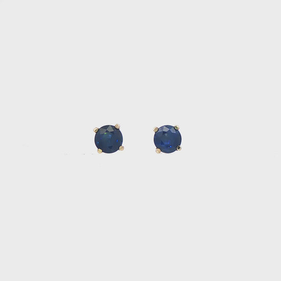 14K White gold stud earrings set with round blue sapphires. Item J35737 - ABC Jewelry Co. 