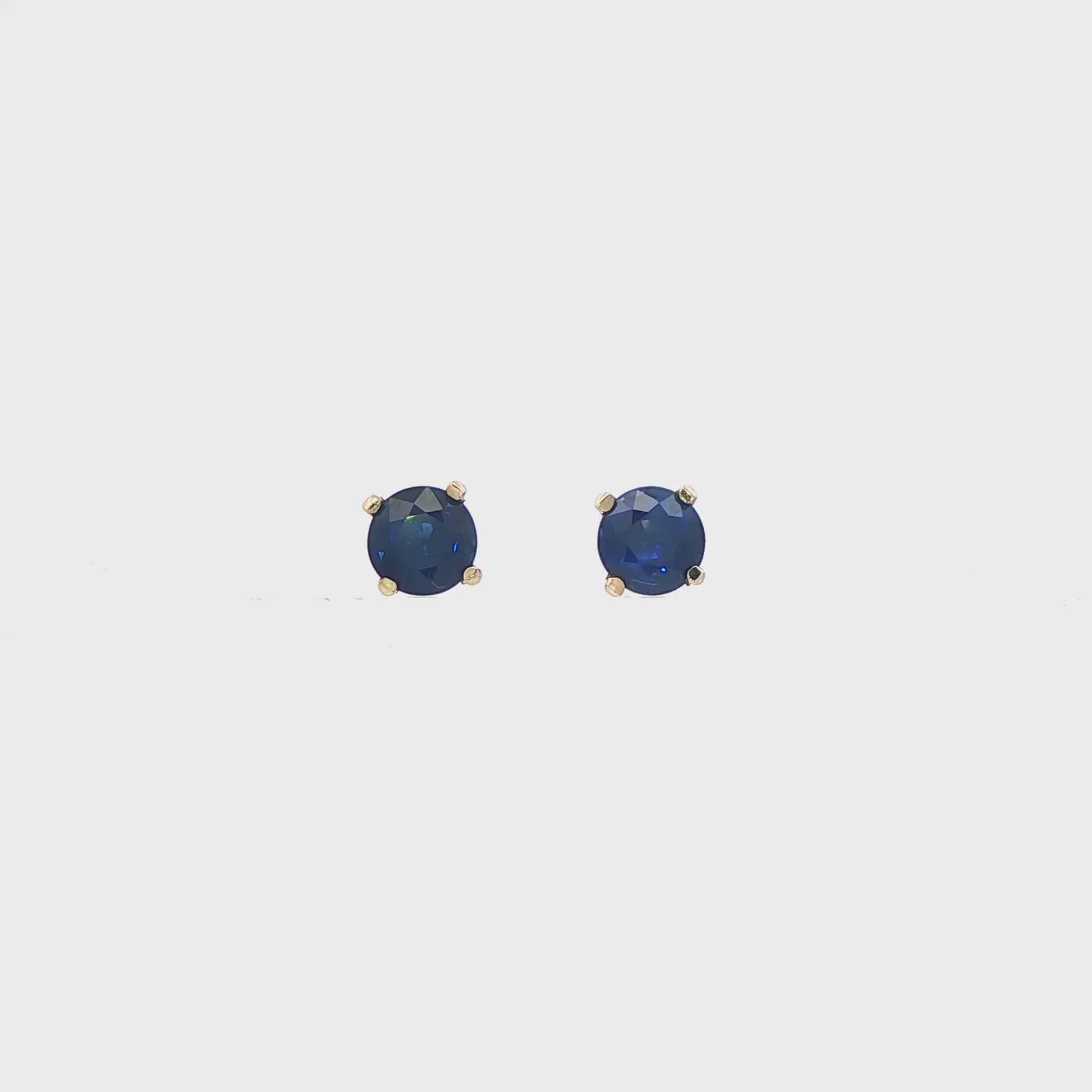 14K White gold stud earrings set with round blue sapphires. Item J35737 - ABC Jewelry Co. 