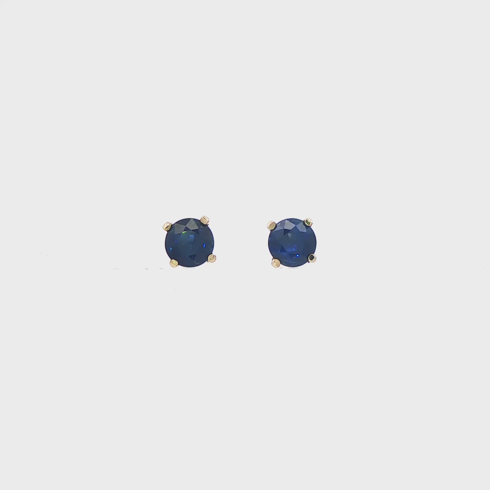 14K White gold stud earrings set with round blue sapphires. Item J35737 - ABC Jewelry Co. 