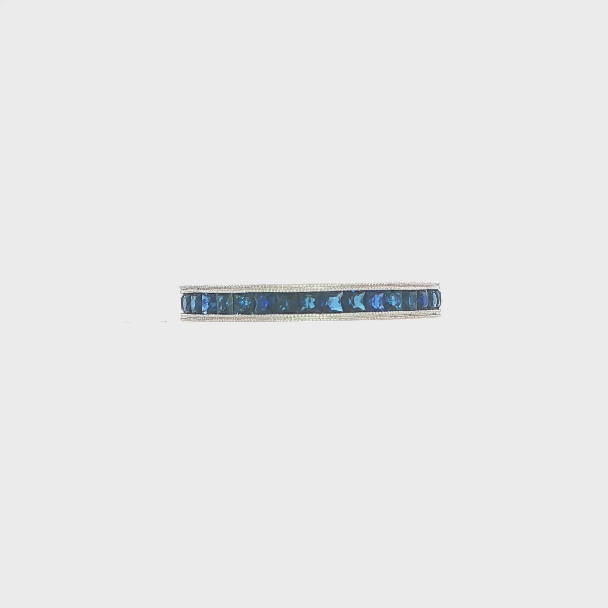 14K White gold eternity band set with princess cut blue sapphires. Item J37260 - ABC Jewelry Co. 
