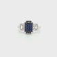14K White gold ring set with an emerald cut sapphire and two diamonds. Item J39215 - ABC Jewelry Co. 
