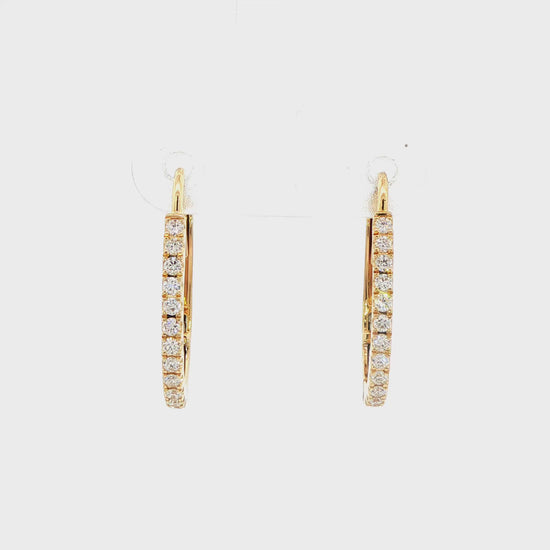 14K Yellow gold oval hoop earrings set with round brilliant diamonds. Item J38769 - ABC Jewelry Co.