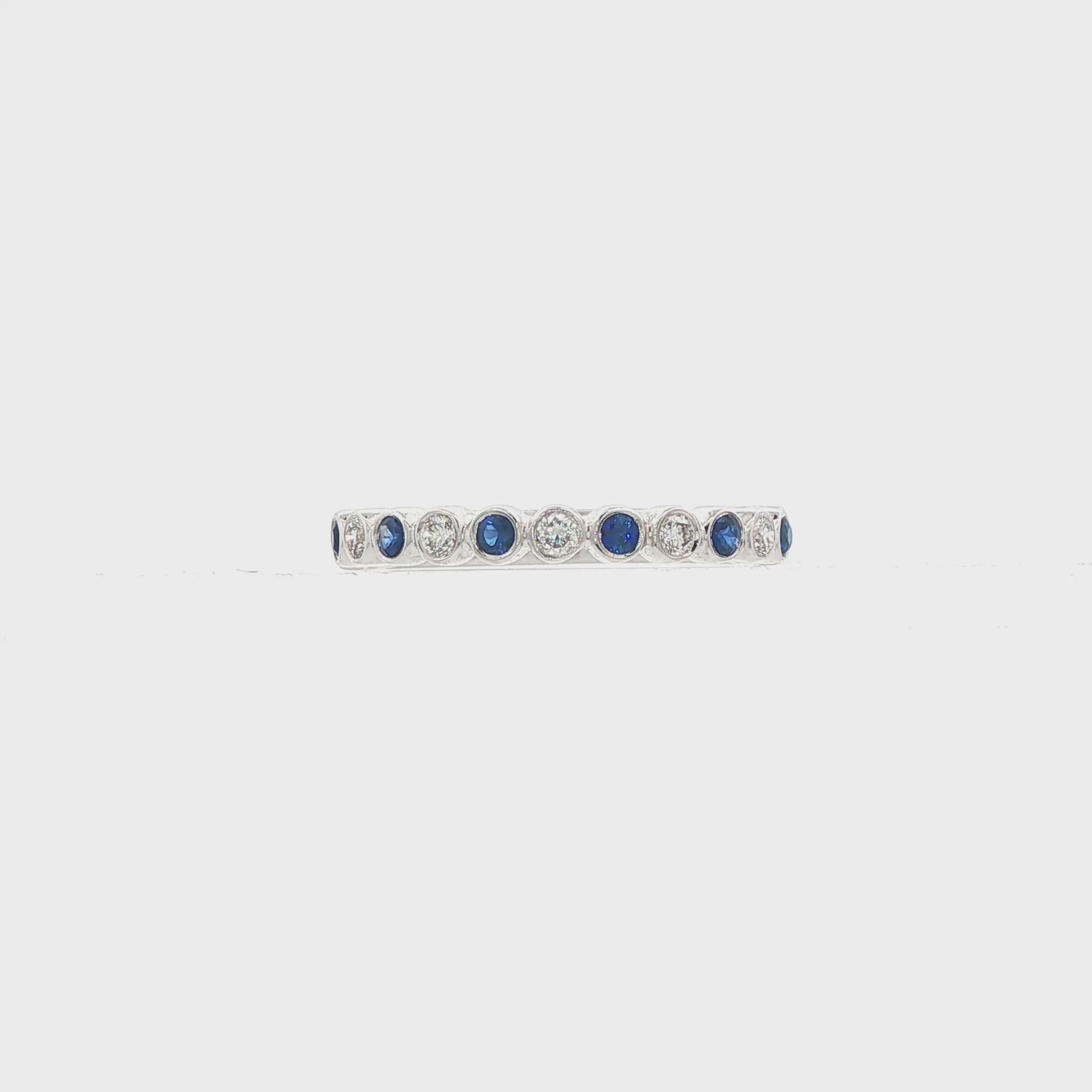 18K White gold band bezel set with alternating diamonds and blue sapphires. Item J36377 - ABC Jewelry Co. 