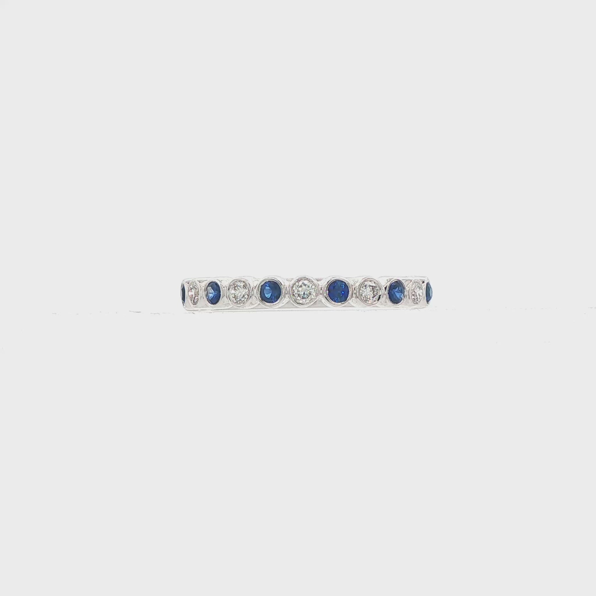 18K White gold band bezel set with alternating diamonds and blue sapphires. Item J36377 - ABC Jewelry Co. 