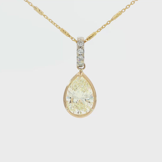 18K Two-tone pendant set with a pear shaped yellow diamond. Item #J39168 - ABC Jewelry Co. 