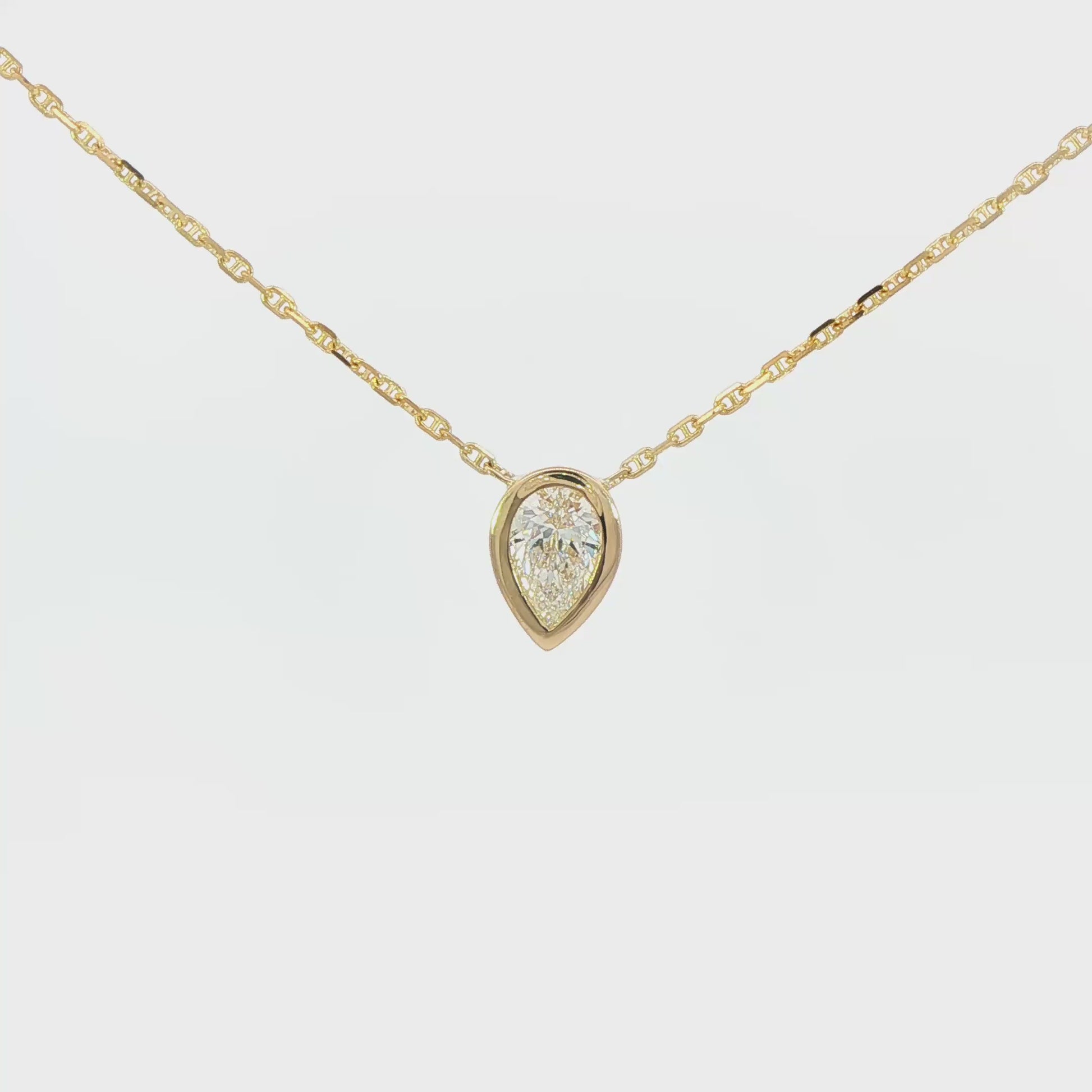 14K Yellow gold necklace bezel set with a pear shape diamond. Item J37647 - ABC Jewelry Co. 