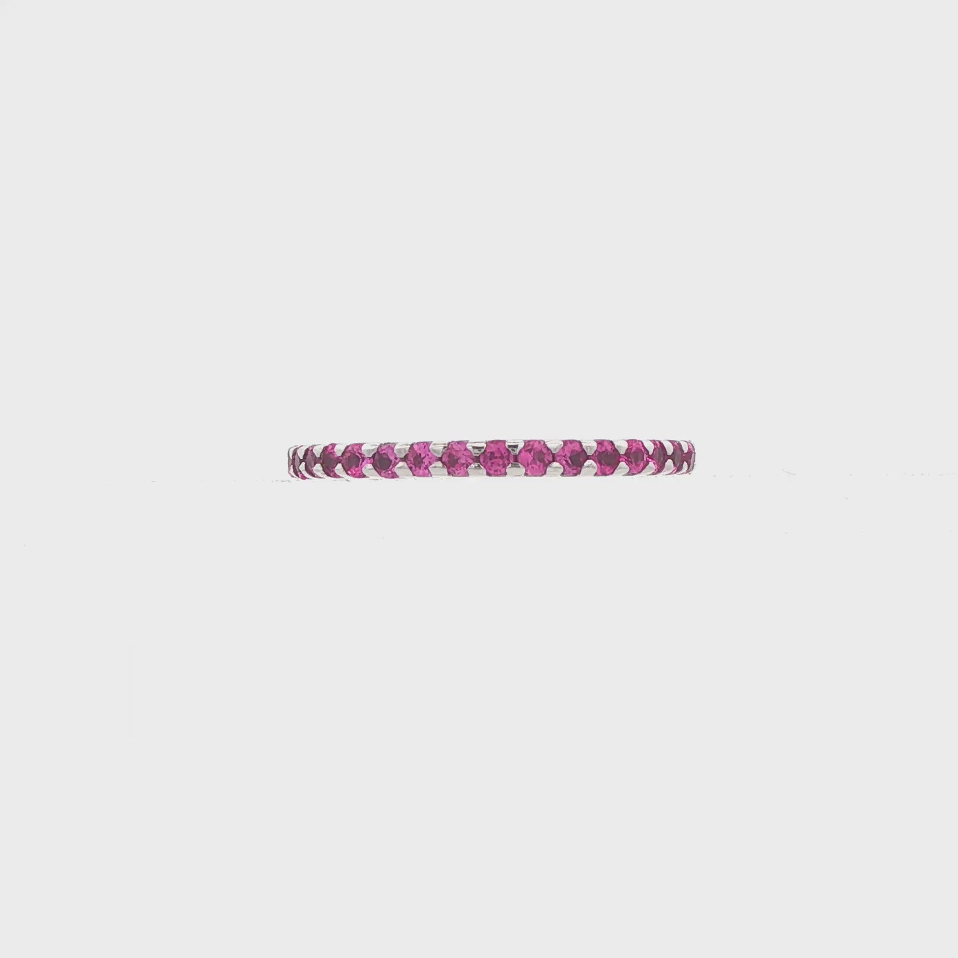 14K White gold eternity band set with pink sapphires. Item 9236 - ABC Jewelry Co.