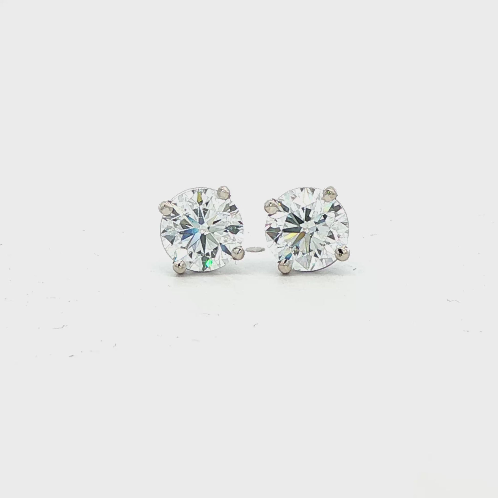 14K White gold diamond stud earrings. Item J38704 - ABC Jewelry Co.