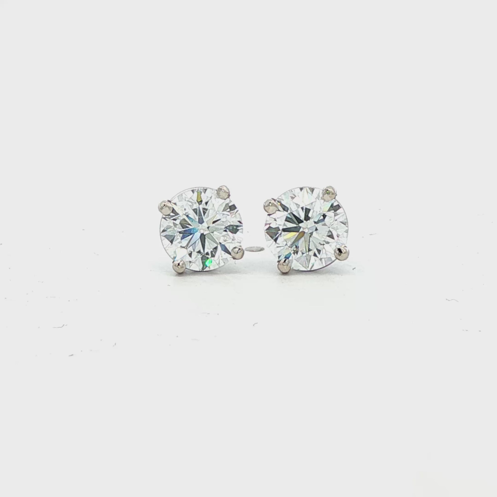 14K White gold diamond stud earrings. Item J38704 - ABC Jewelry Co.