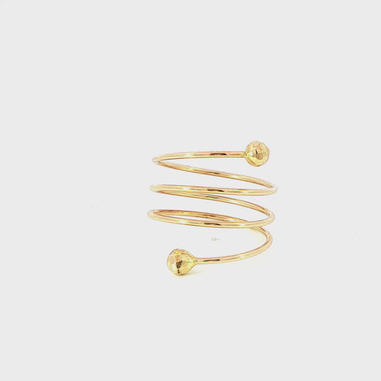 14K Yellow gold spiral ring with faceted balls on each end. Item J35548 - ABC Jewelry Co.