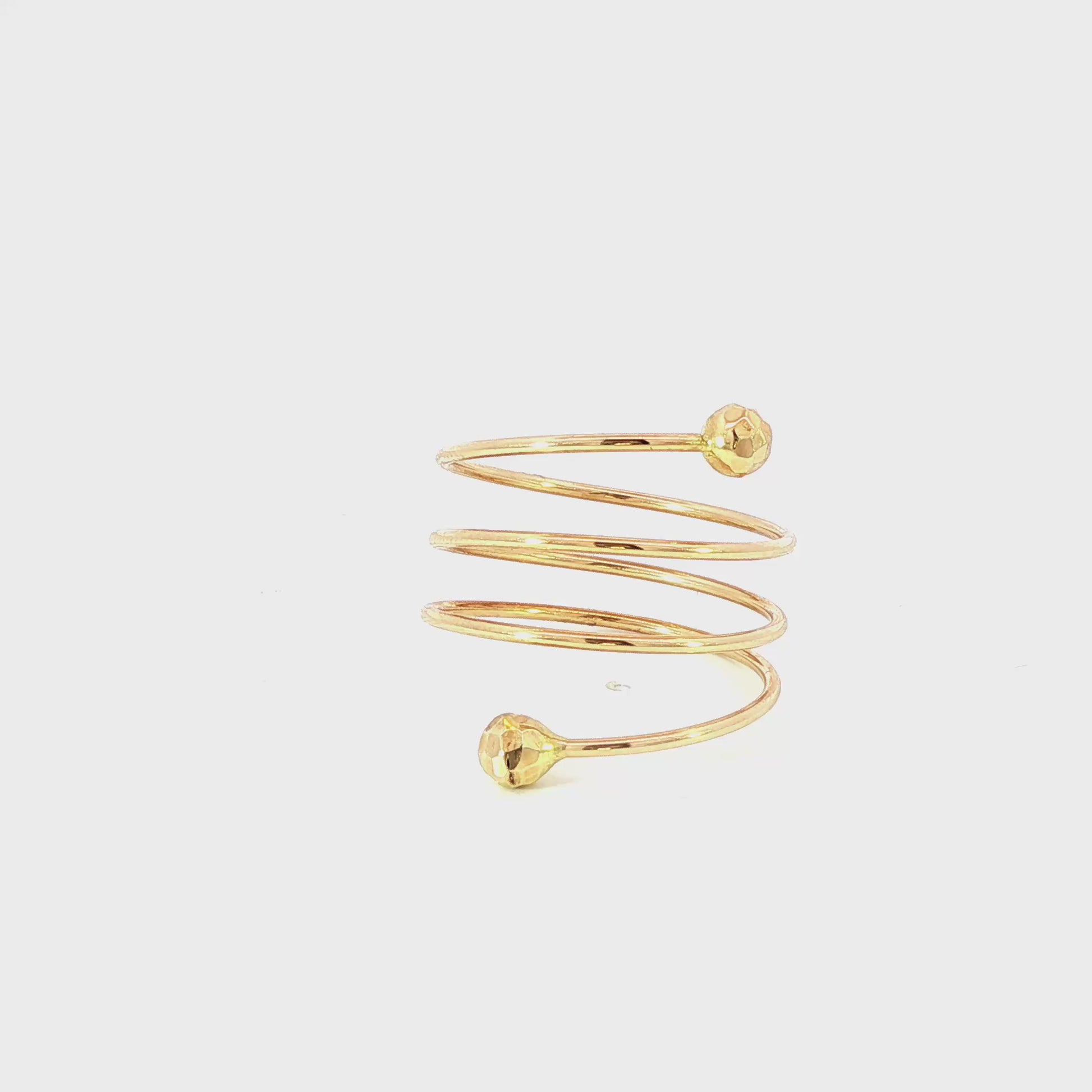 14K Yellow gold spiral ring with faceted balls on each end. Item J35548 - ABC Jewelry Co.