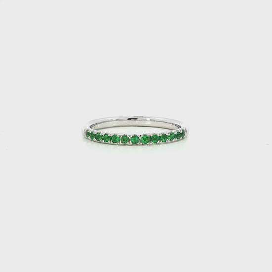 18K White gold band set with round green emeralds. Item J36909 - ABC Jewelry Co