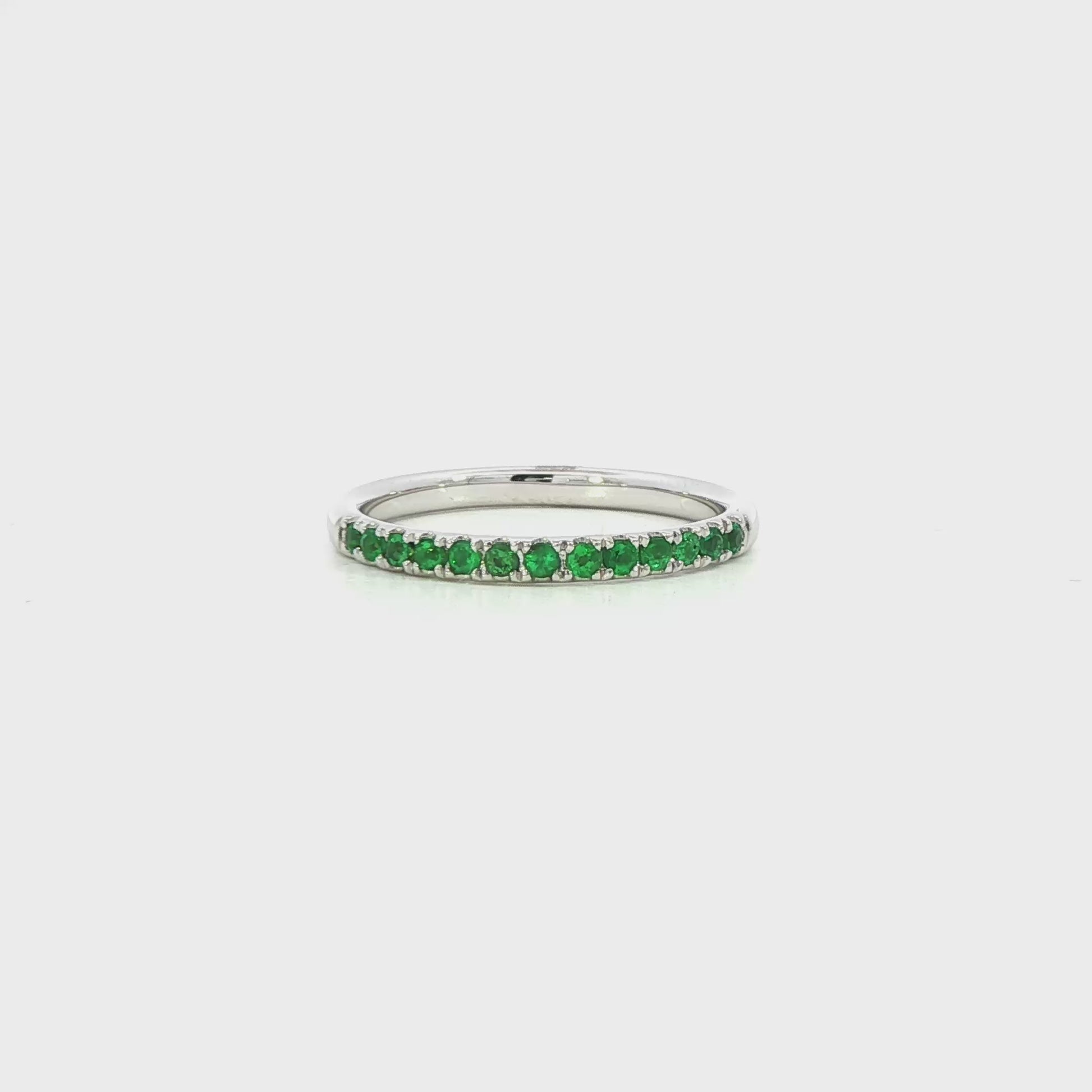 18K White gold band set with round green emeralds. Item J36909 - ABC Jewelry Co