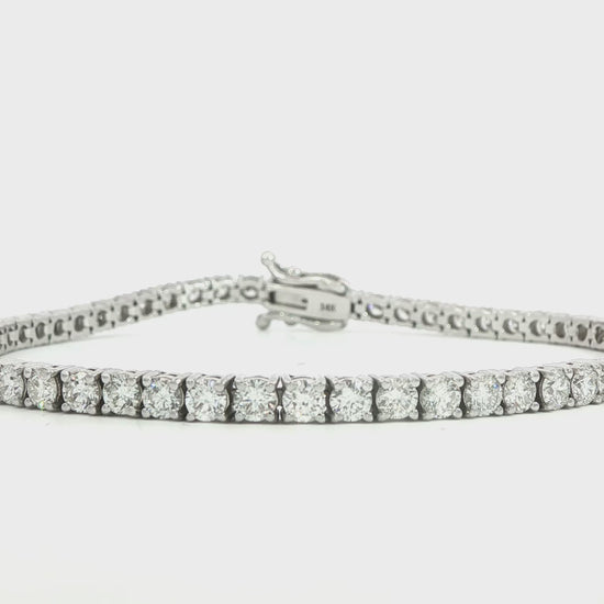 14K White gold tennis bracelet set with round brilliant diamonds. Item J38810 - ABC Jewelry Co