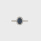 18K White gold ring set with an oval blue sapphire surrounded by a diamond halo. Item J30904 - ABC Jewelry Co. 