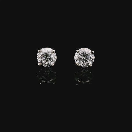 14K White gold stud earrings set with round brilliant diamonds. Item J34122 - ABC Jewelry Co.