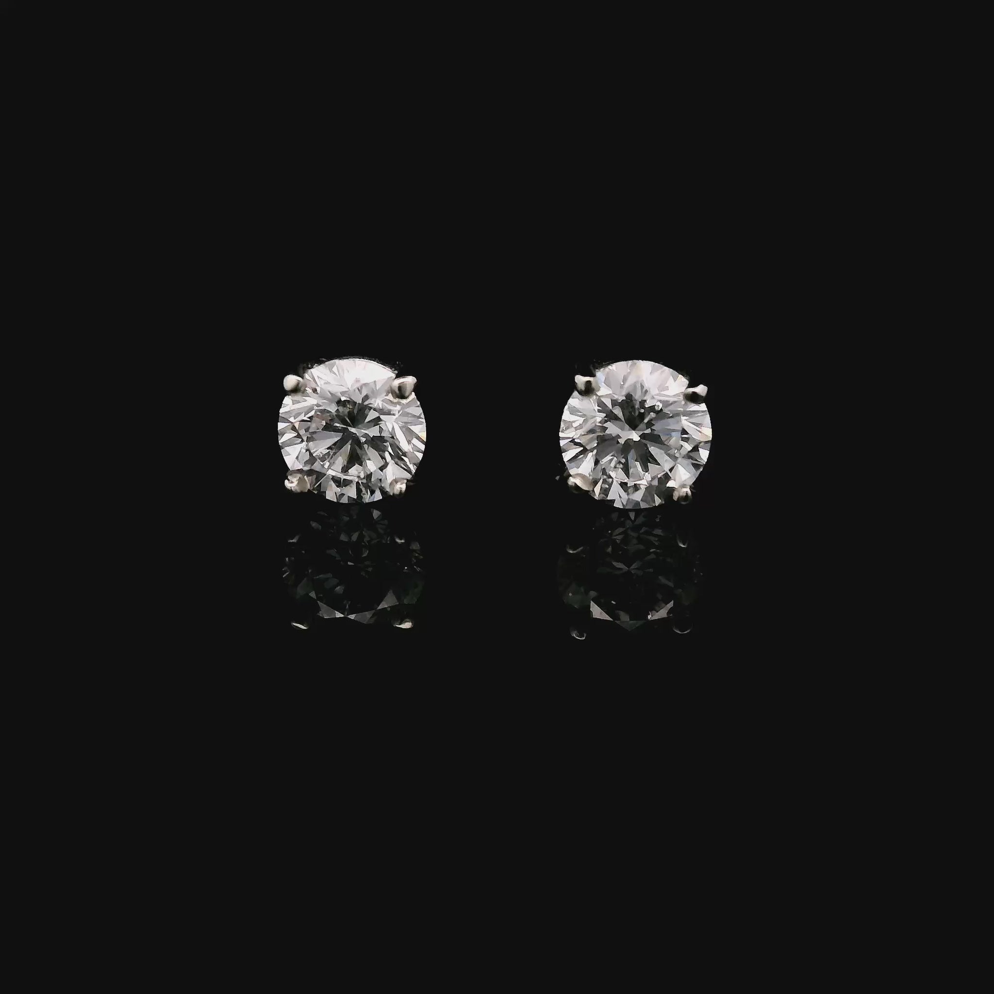 14K White gold stud earrings set with round brilliant diamonds. Item J34122 - ABC Jewelry Co.
