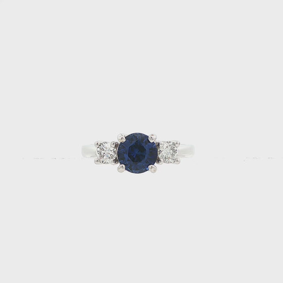 18K White gold ring set with one round blue sapphire and two round brilliant diamonds. Item J37692 - ABC Jewelry Co. 