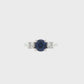 18K White gold ring set with one round blue sapphire and two round brilliant diamonds. Item J37692 - ABC Jewelry Co. 