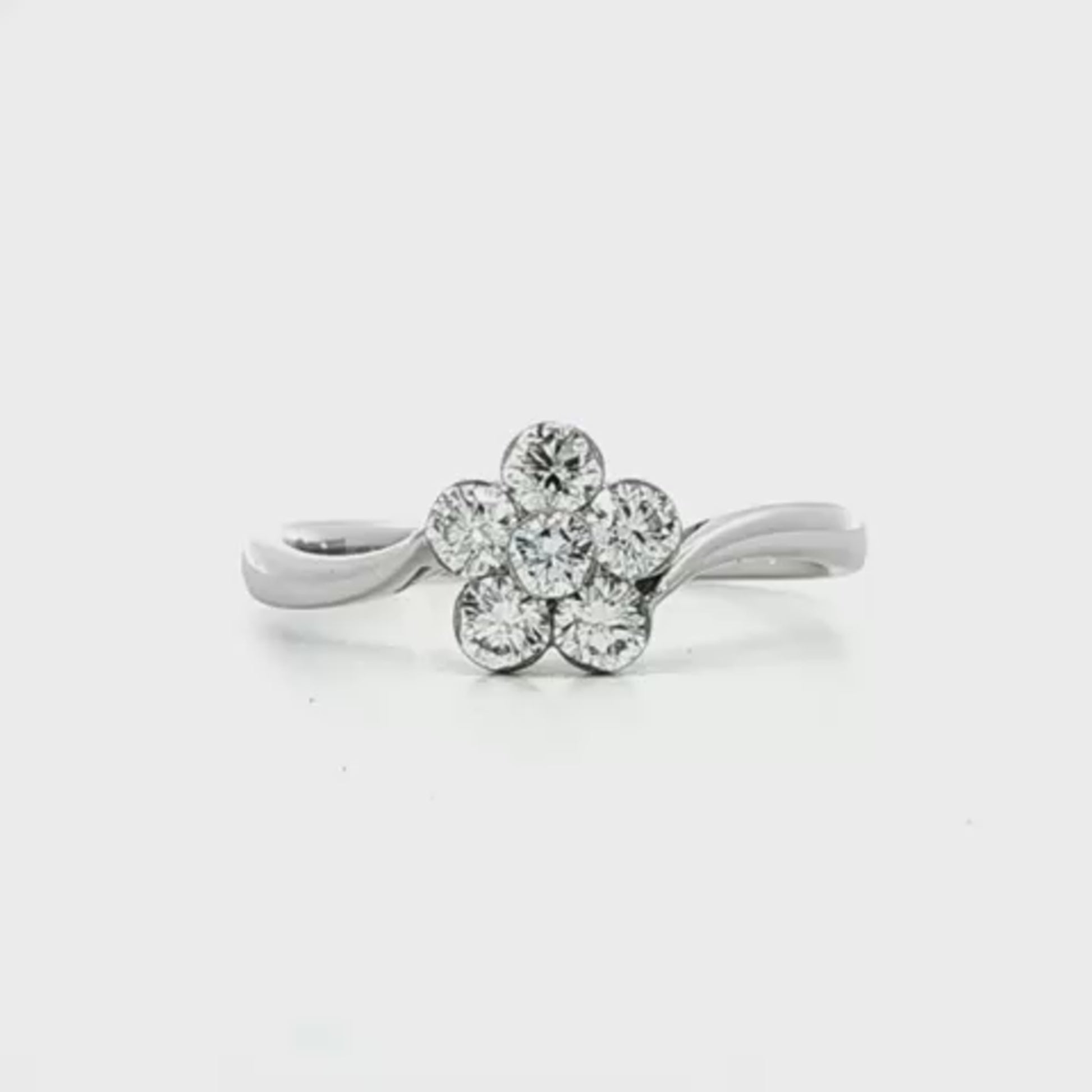 18K White gold diamond cluster ring in floral design with bypass style shank. Item J33161 - ABC Jewelry Co