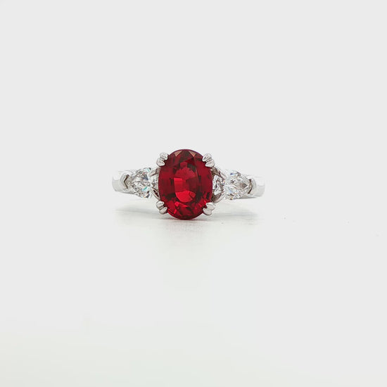 14K White gold ring with red ruby center and pear shape diamond shoulders. Item J35580 - ABC Jewelry Co. 