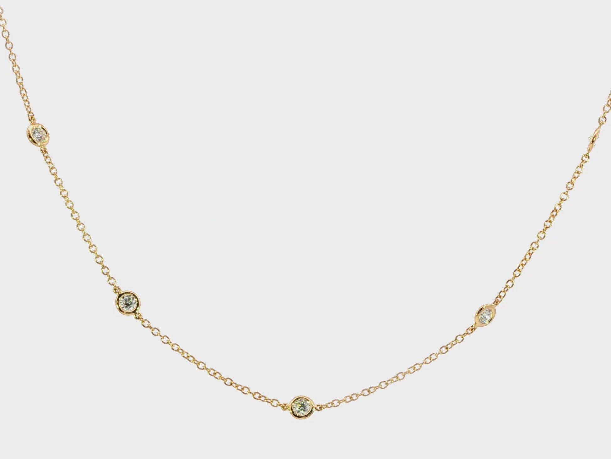 18K Yellow gold necklace with bezel set round brilliant diamonds set along the chain. Item J38856 - ABC Jewelry Co. 