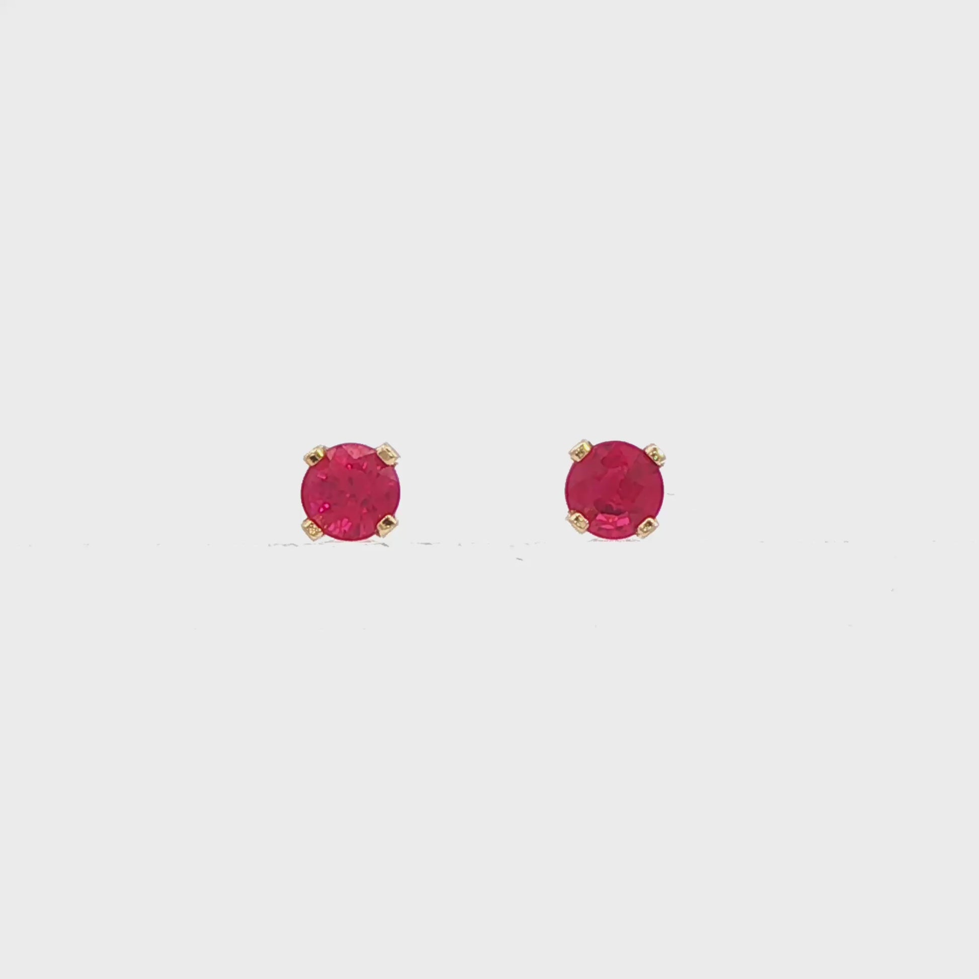 14K Yellow gold stud earrings set with round rubies. Item J34286 - ABC Jewelry Co.
