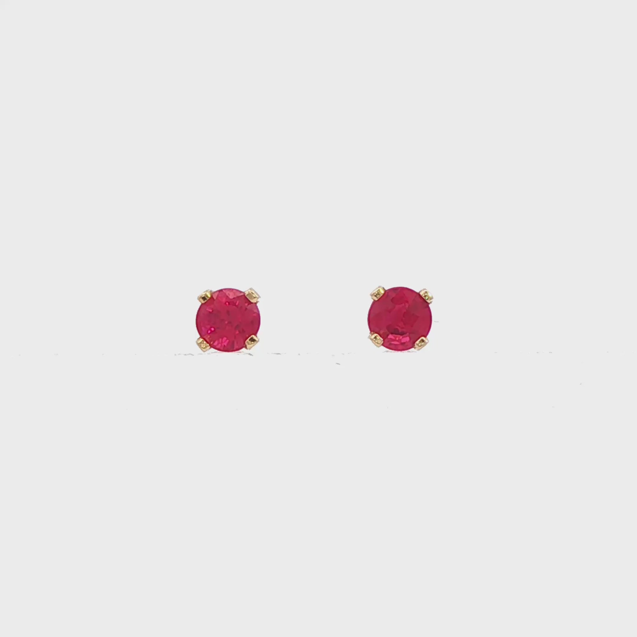 14K Yellow gold stud earrings set with round rubies. Item J34286 - ABC Jewelry Co.