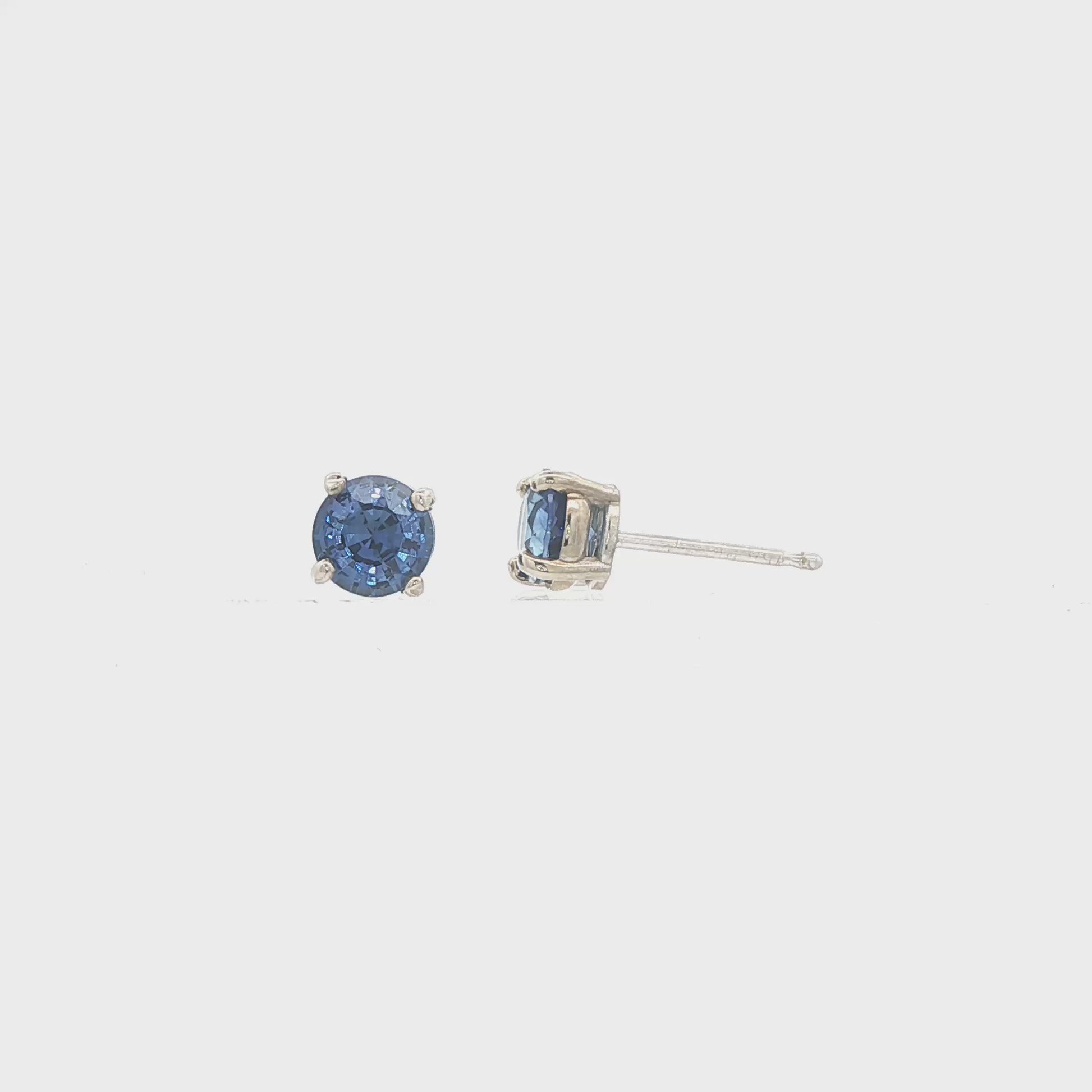 14K White gold stud earrings set with round blue sapphires. Item J37904 - ABC Jewelry