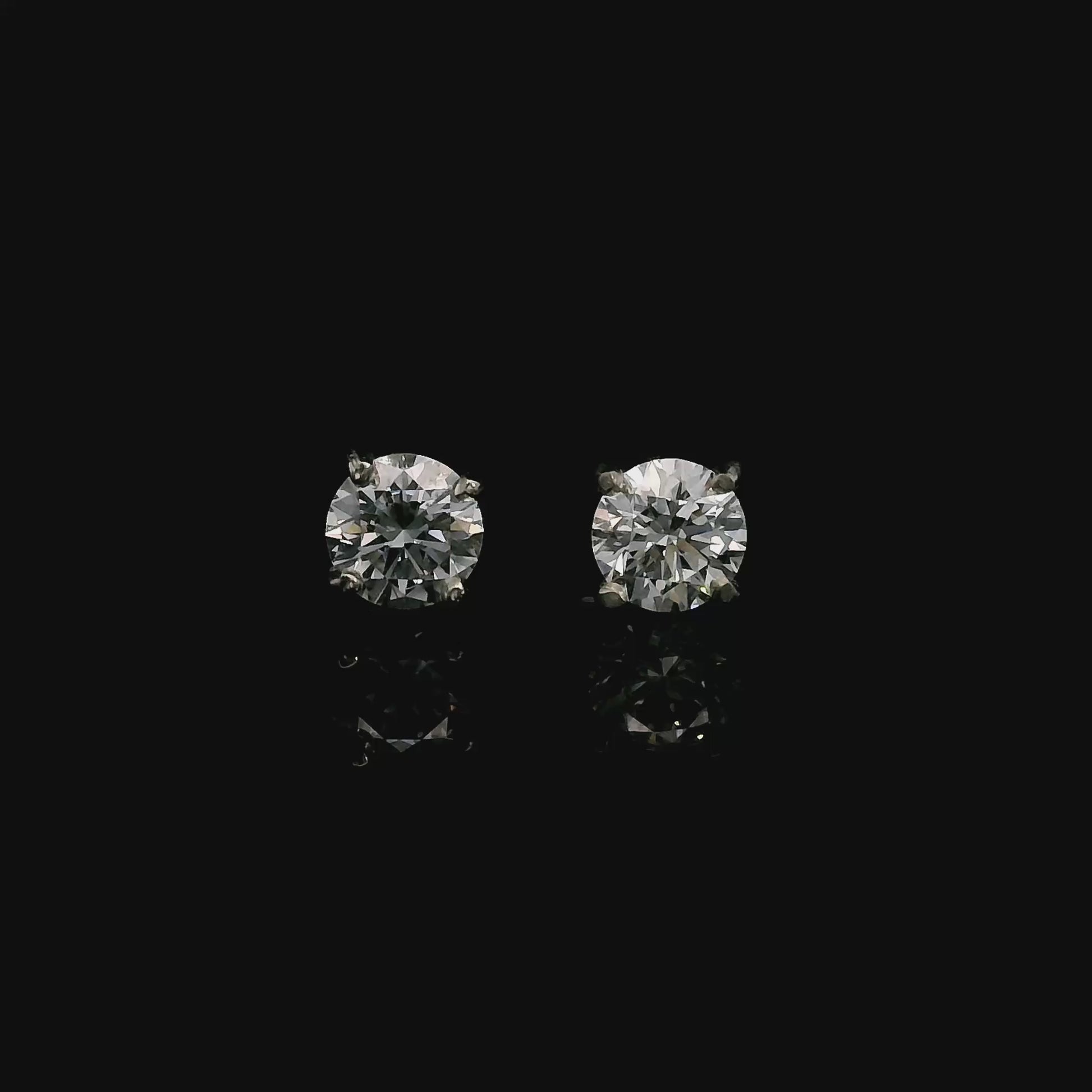 14K White gold stud earrings set with round brilliant diamonds. Item J39014 - ABC Jewelry Co. 