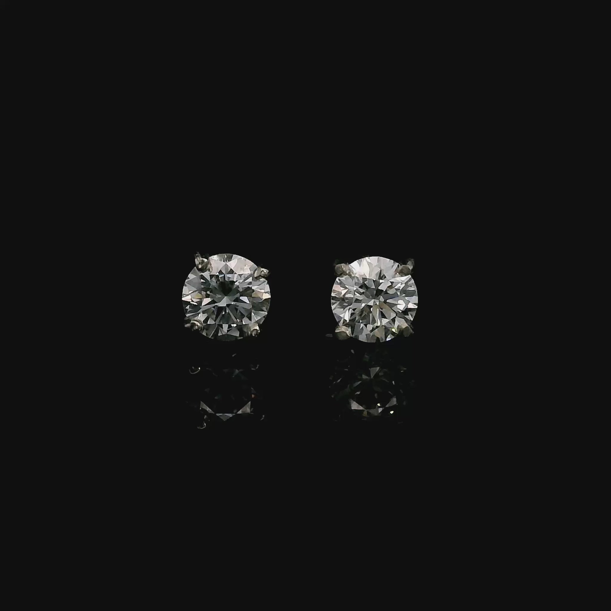 14K White gold stud earrings set with round brilliant diamonds. Item J39014 - ABC Jewelry Co. 