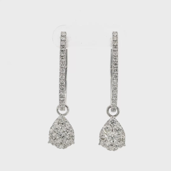 18K White gold earring jackets featuring clusters of diamonds, shown on white gold diamond hoop earrings. Item J35758 - ABC Jewelry Co