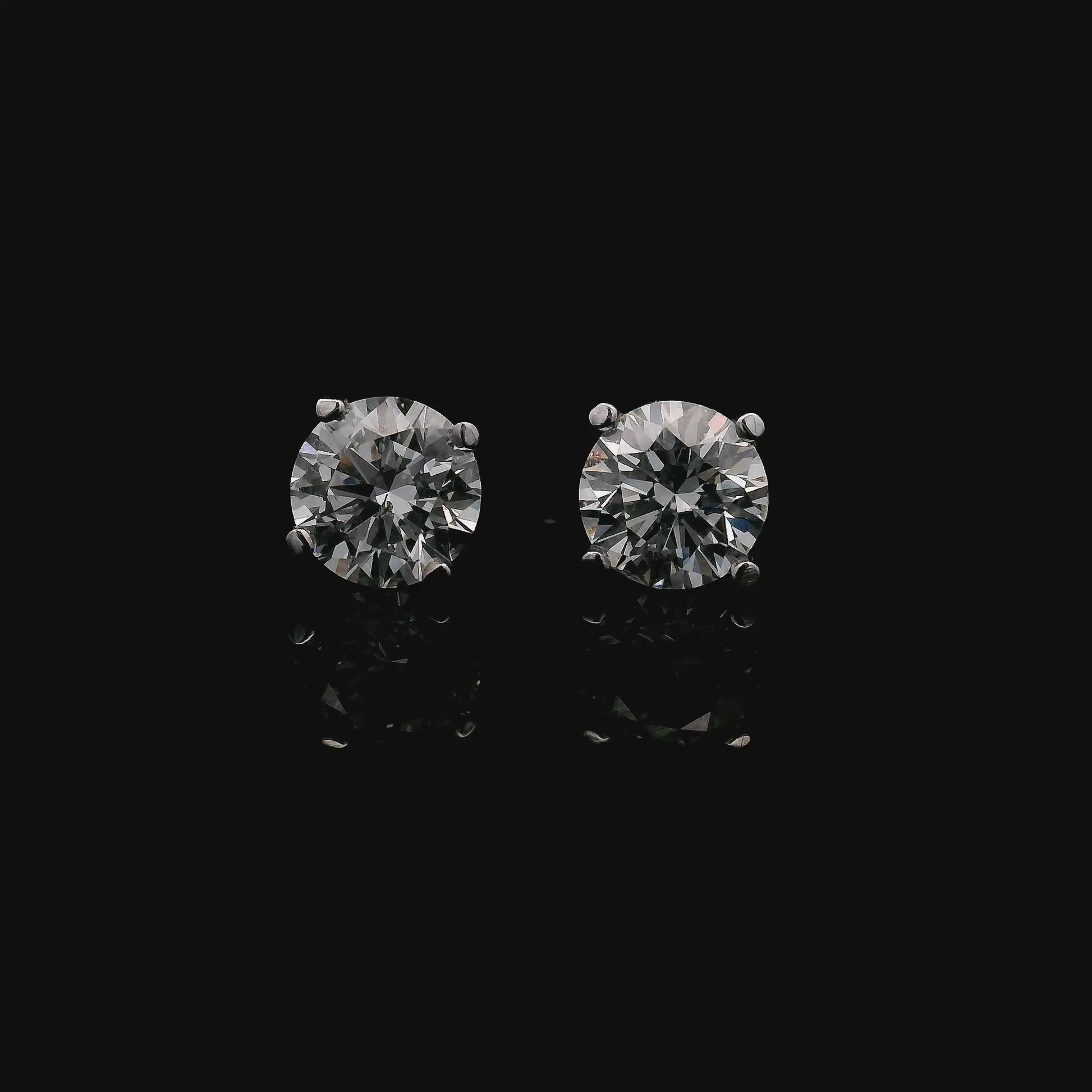 14K White gold stud earrings set with round brilliant diamonds. Item J37751 - ABC Jewelry Co.