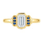 Yellow gold art deco ring with an emerald cut diamond an3 small blue sapphires on either side. Set on a white background.